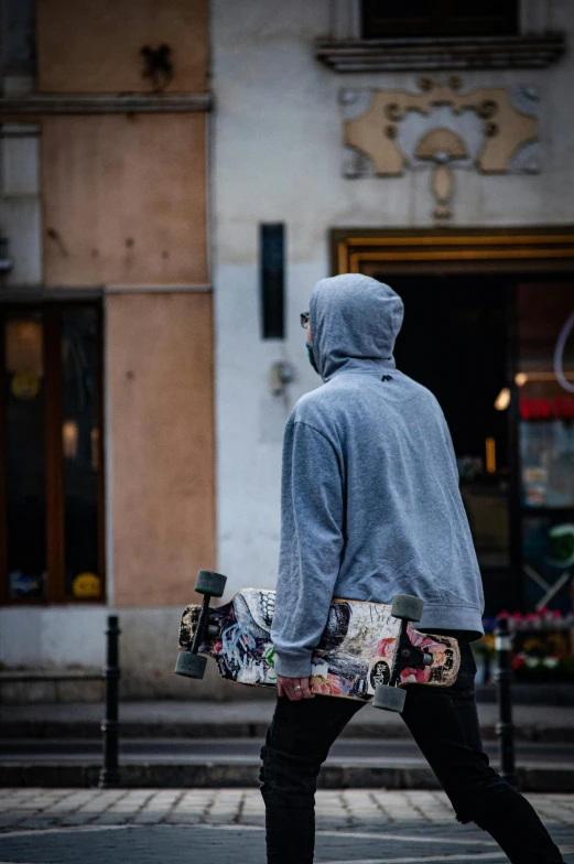 a man with a skateboard walking down a street
