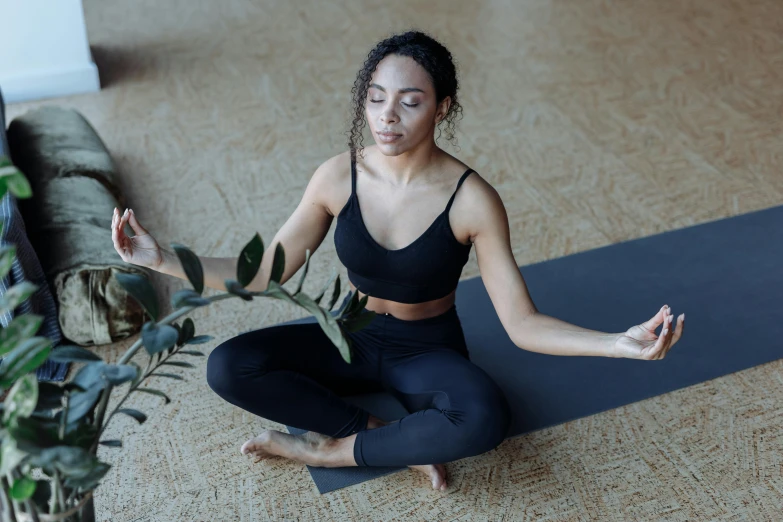 a woman is practicing yoga on the ground