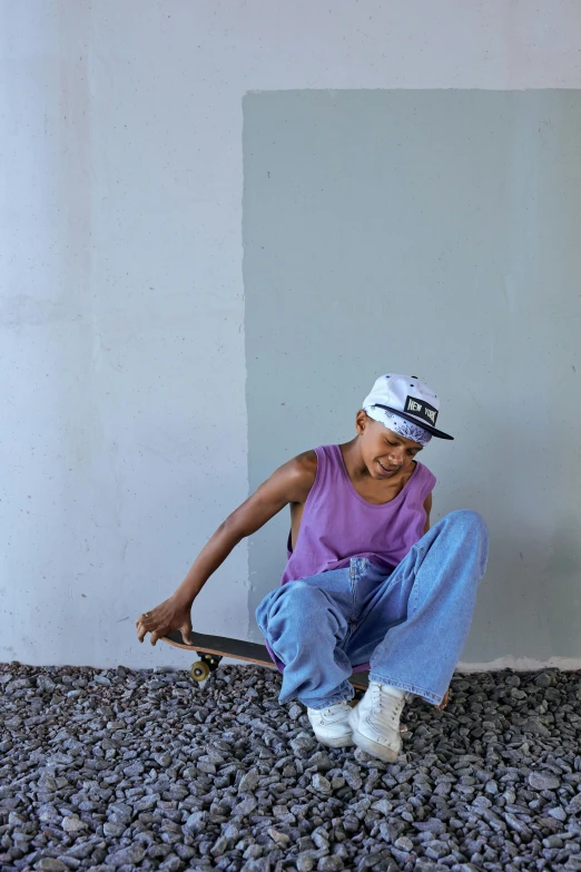 a person sitting on the ground with a skateboard