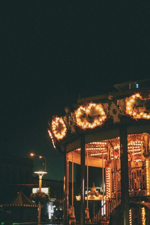 a merry go round on a city street at night