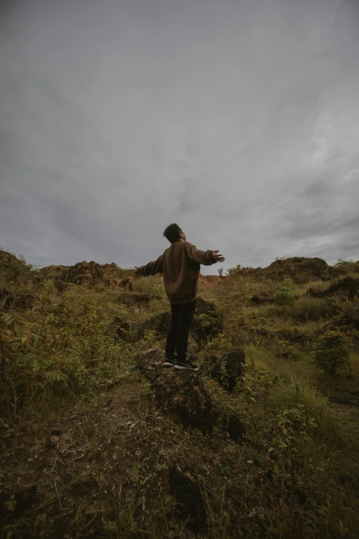 a person standing on top of a grass covered field