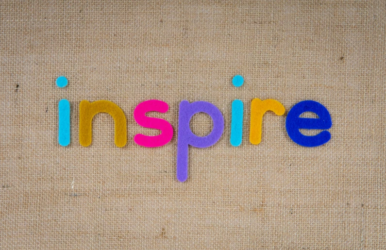 a po of the word inspire in colored letters