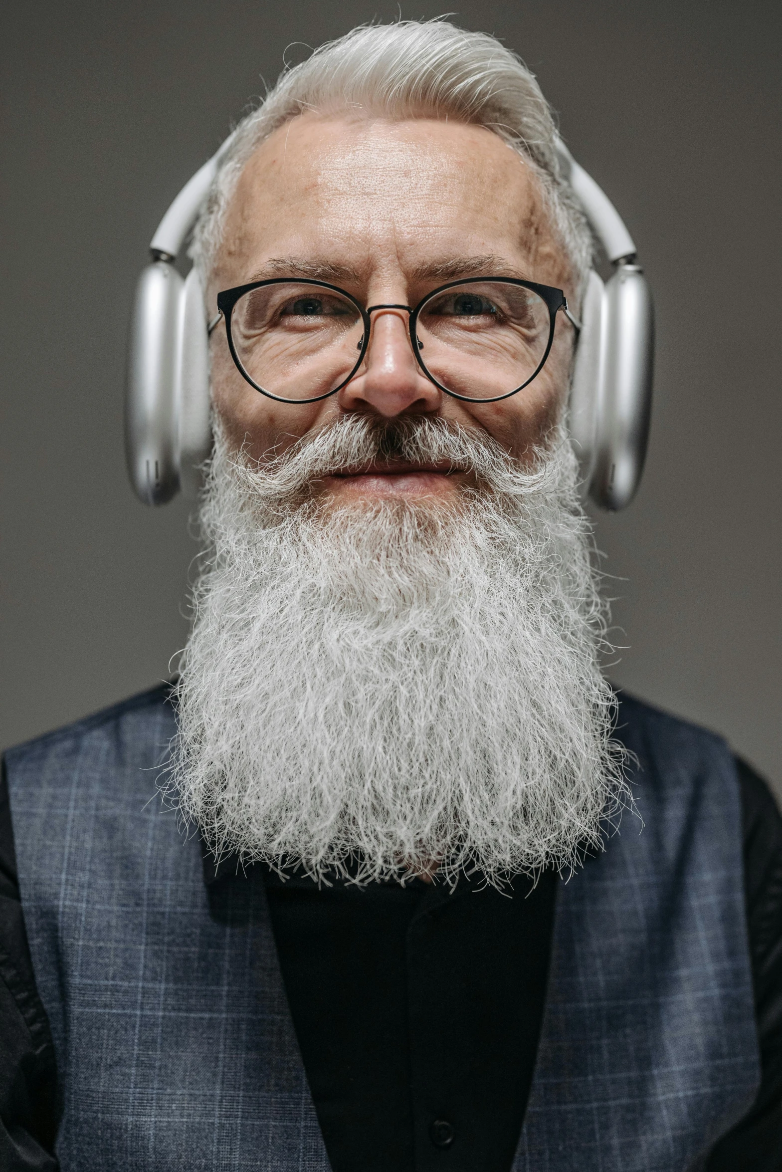 a man with long grey hair wearing headphones