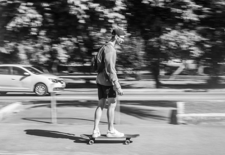 a man is riding his skateboard down the street