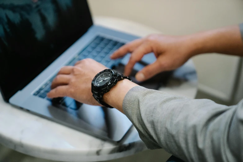 the person is using his laptop while working on it