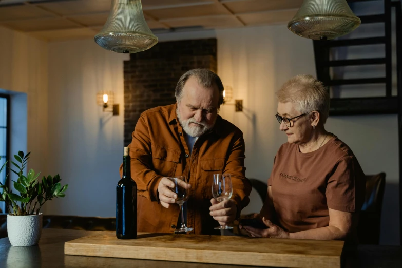 a man and a woman holding glasses at a table