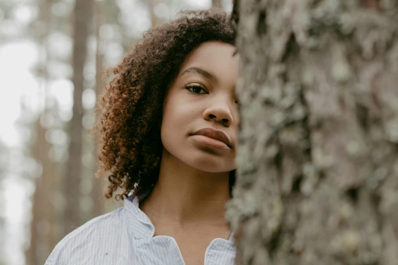 a close up s of a woman in a forest