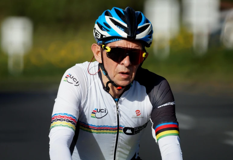 a man riding a bike on top of a road