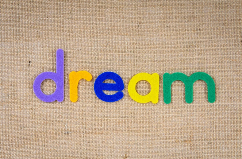a word that says dream in several colored letters