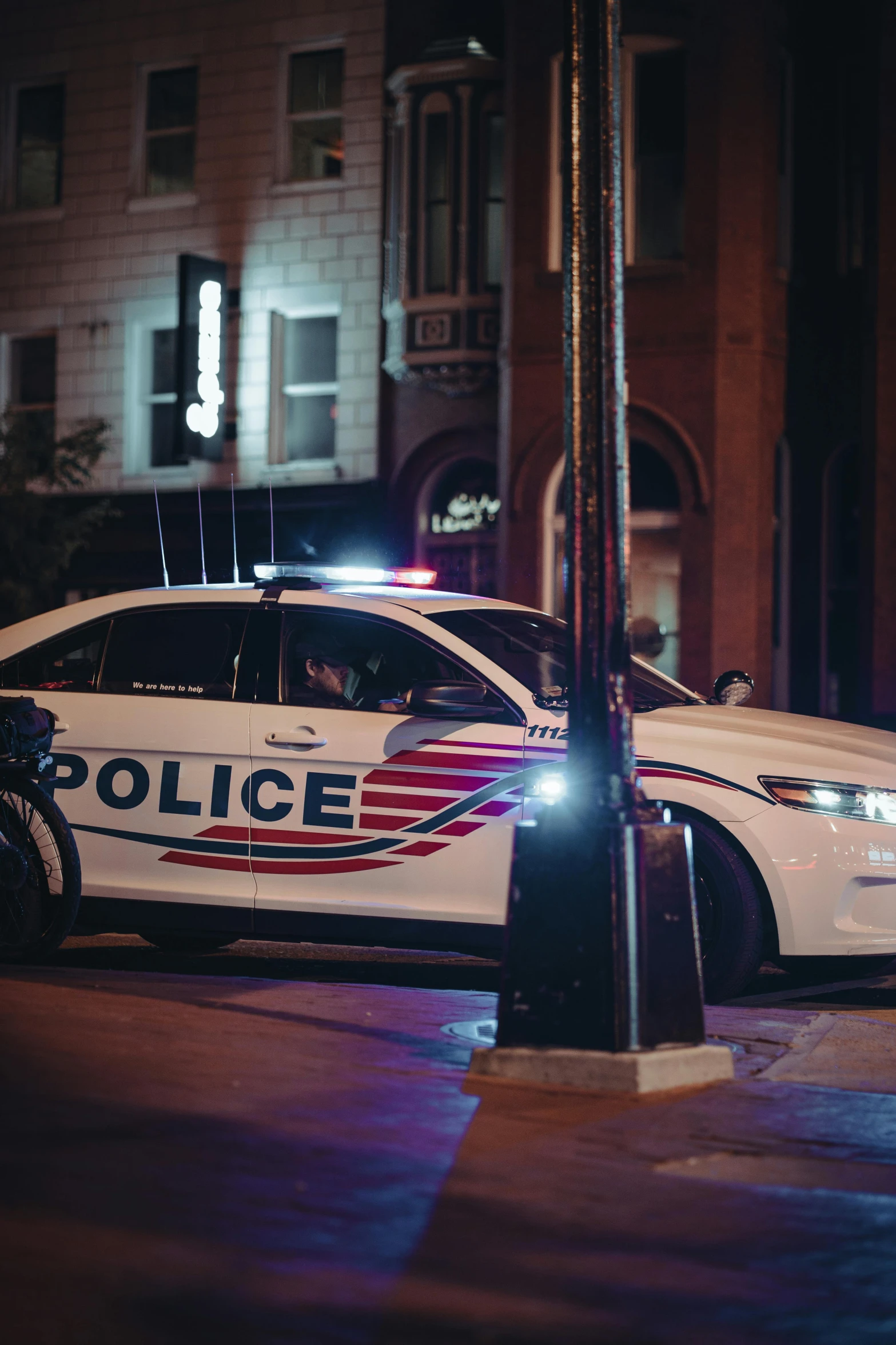 police car parked in the middle of town at night