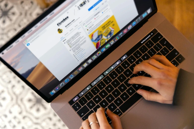 a person is typing on a keyboard on a laptop