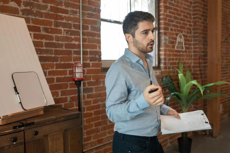 a man talking into a microphone while holding soing