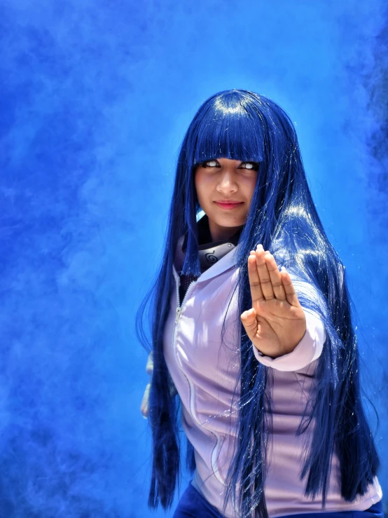 a girl with blue hair with an invisible wig posing