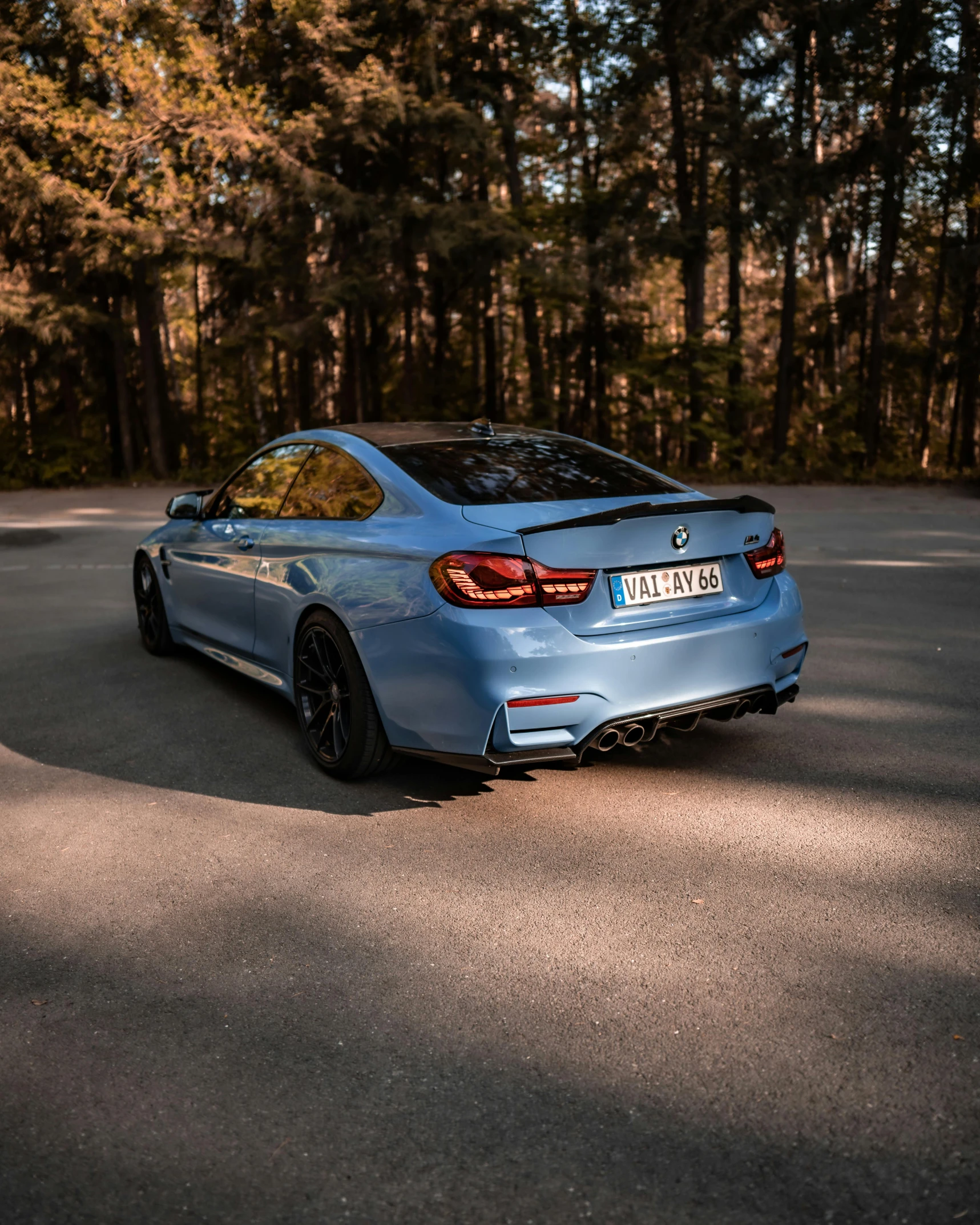 a blue car parked on the side of a road