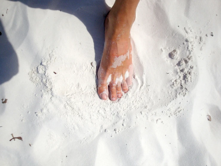 a persons feet in the snow while it is cold