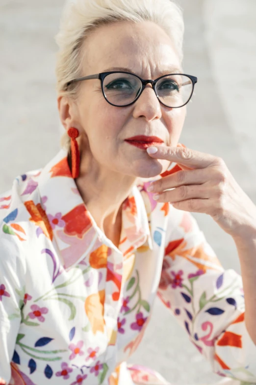 a beautiful woman in a floral shirt posing for a picture