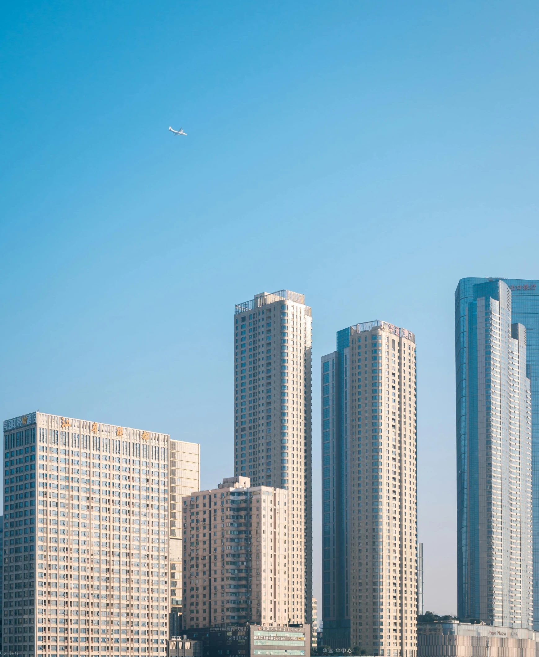 tall buildings near water and sky line with sailboats in foreground