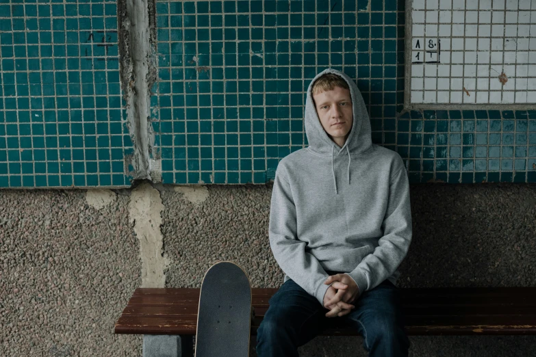 there is a young man sitting on a bench