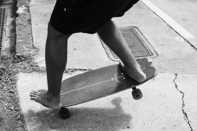 a person is riding a skateboard along the street