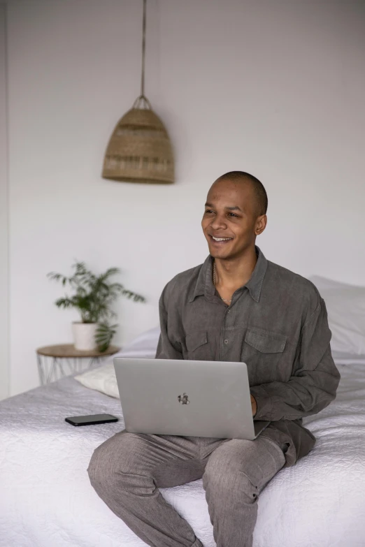 a person that is sitting down on a bed