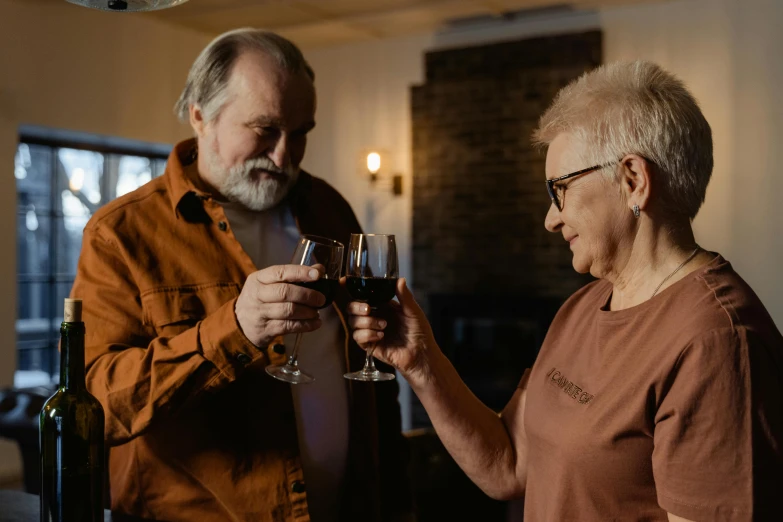 a man holding a wine glass with a woman