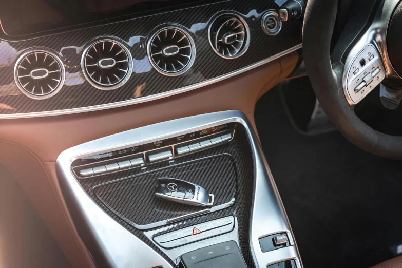 the inside of a car shows controls, dashboard and steering wheel