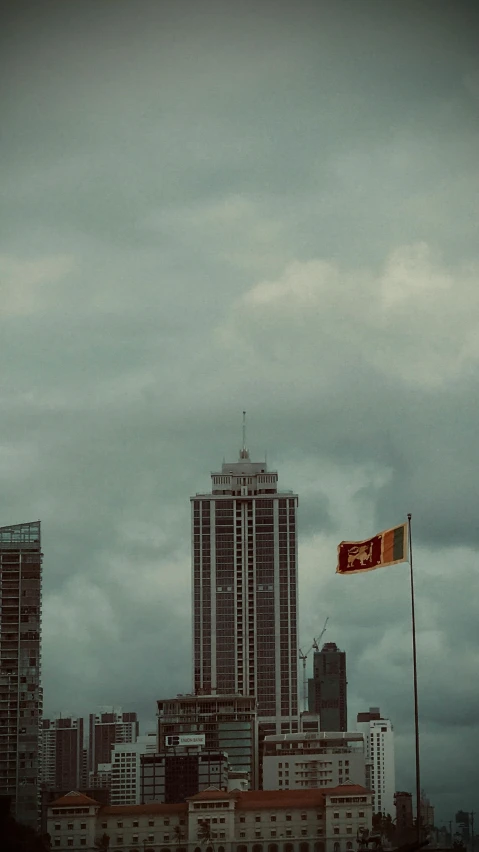 a red and white flag near some large building