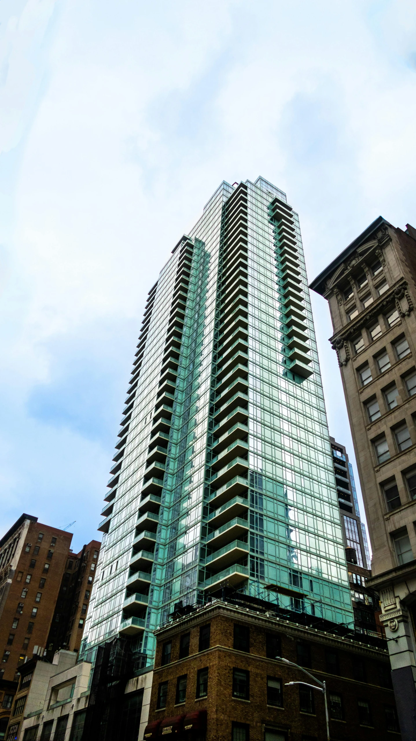 the tall building is in front of other large buildings