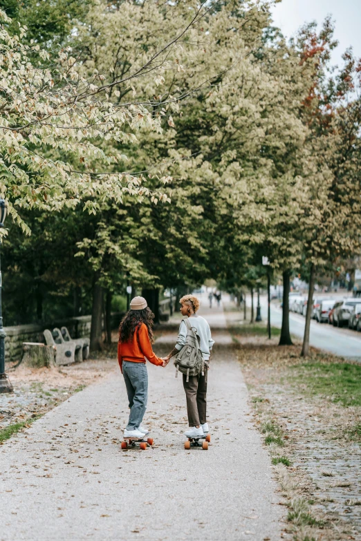 two people are walking down the road together