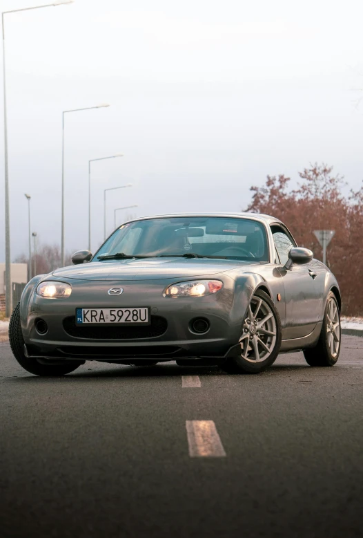 the car is driving on a street in the winter