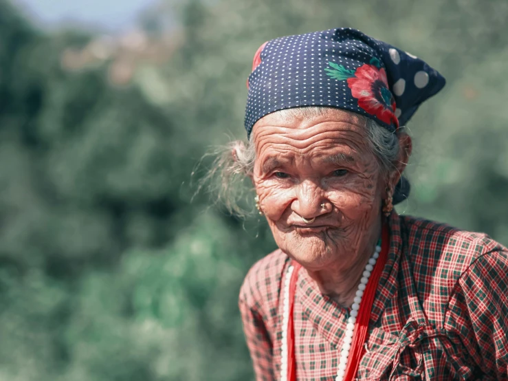 an elderly asian lady with hair in ponytails