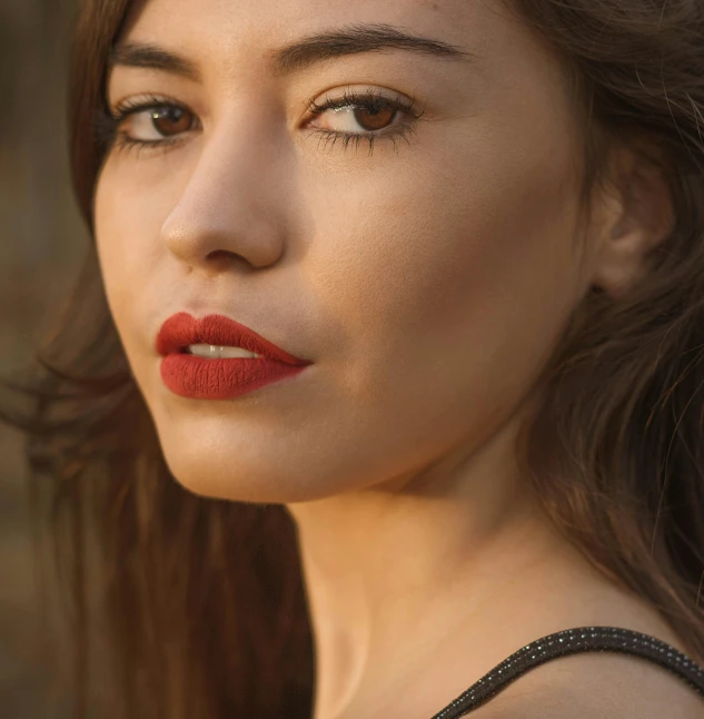 a woman with red lipstick wearing a dress