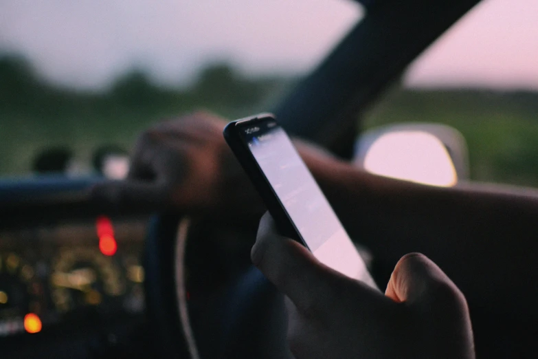 someone using their cell phone while driving a car