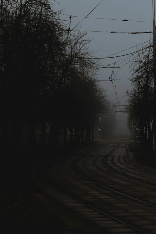 a line of power lines over an empty road