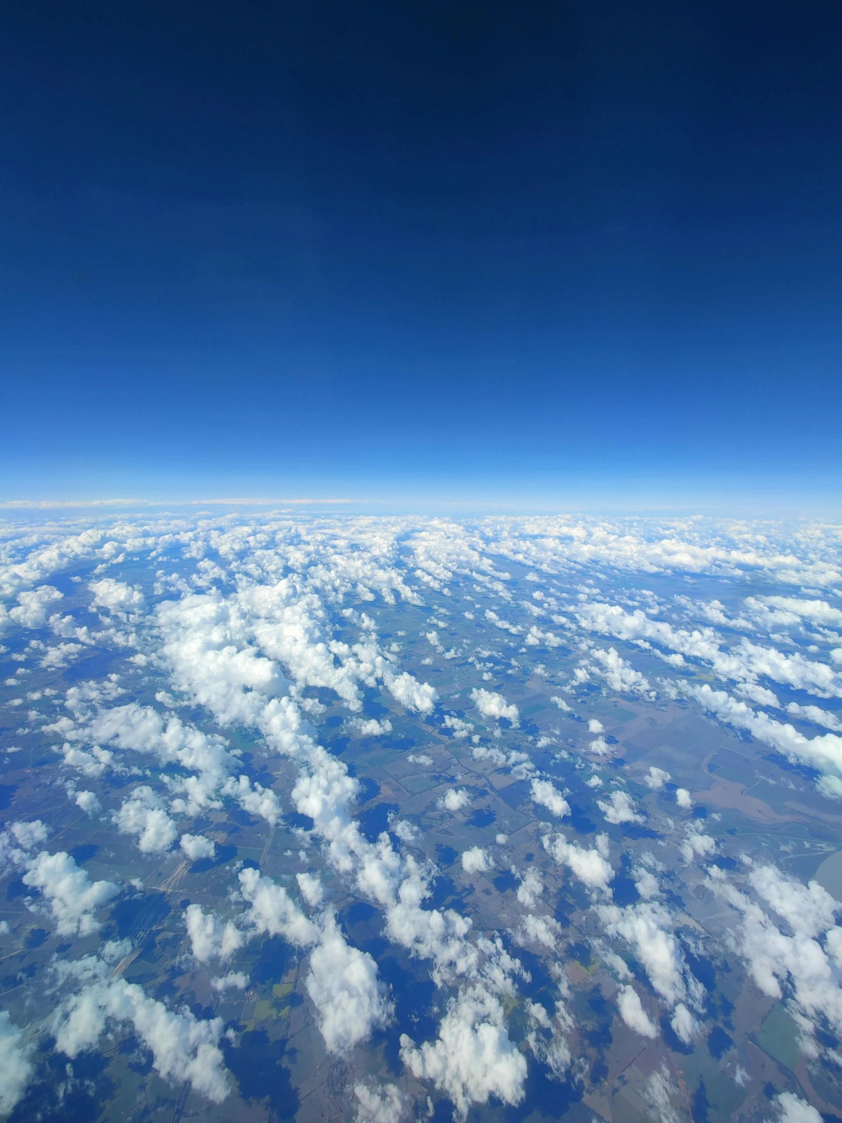 view from an airplane looking into the sky over clouds