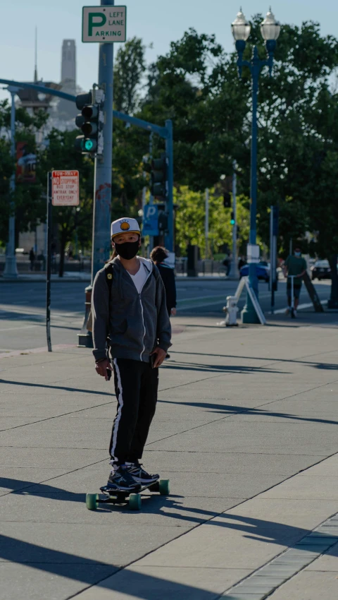 skateboarder on sidewalk with helmets looking around