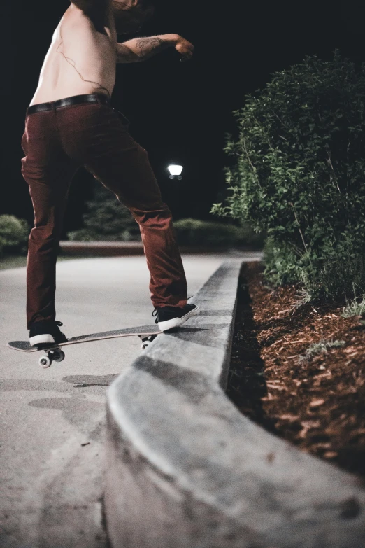 a man riding a skateboard on top of a sidewalk