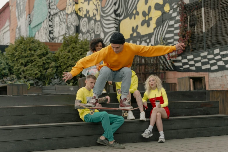 a group of s sitting down on stairs with a person doing a skateboarding trick