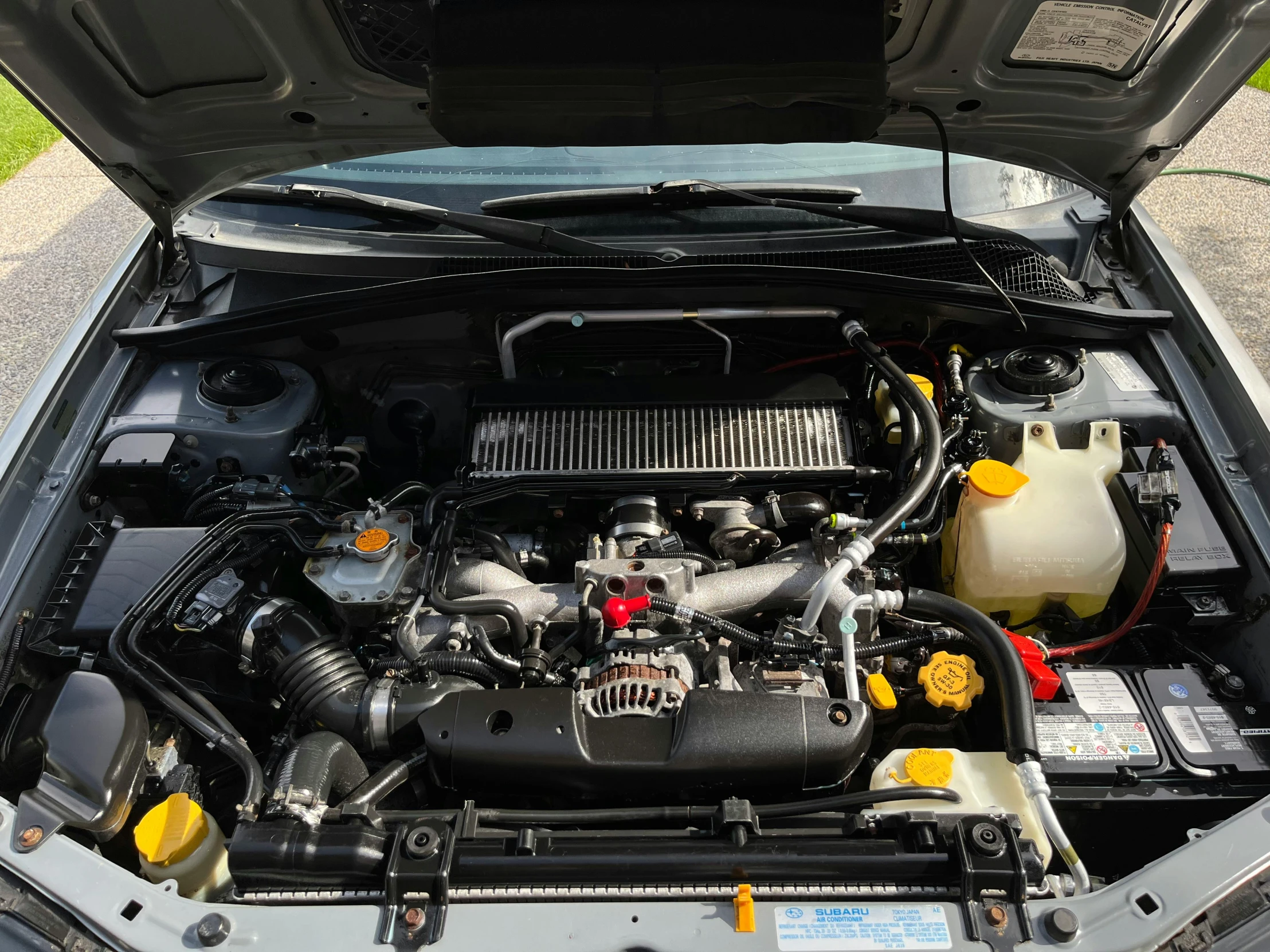 the engine of a car is parked on the side of the street