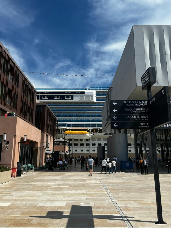 a black street sign in front of some buildings