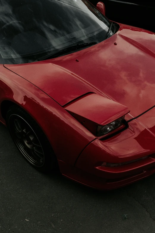 a red car parked next to another black car