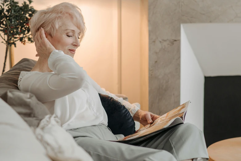 the woman is listening to her music while sitting on the couch