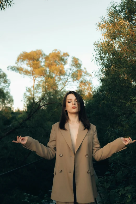 a woman standing with her arms spread wide