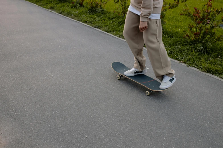 a skateboarder wearing tan and black shoes doing a trick