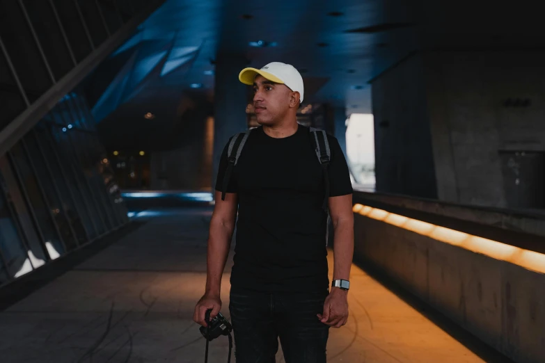 a man with a hat and a skateboard at night