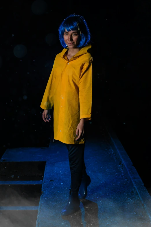 a woman is dressed in yellow and posing