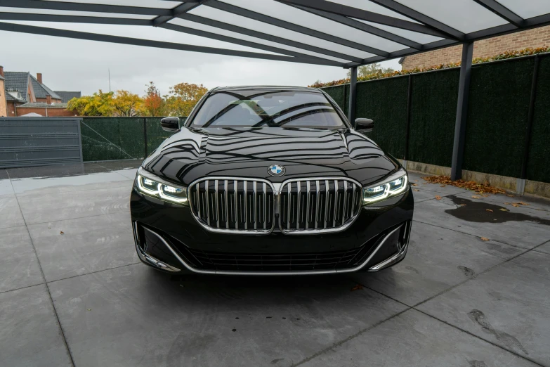 a bmw luxury car parked under a pergolated awning