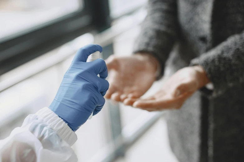 a person with latex glove holding soing