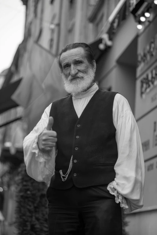 a man with a beard and vest standing outside