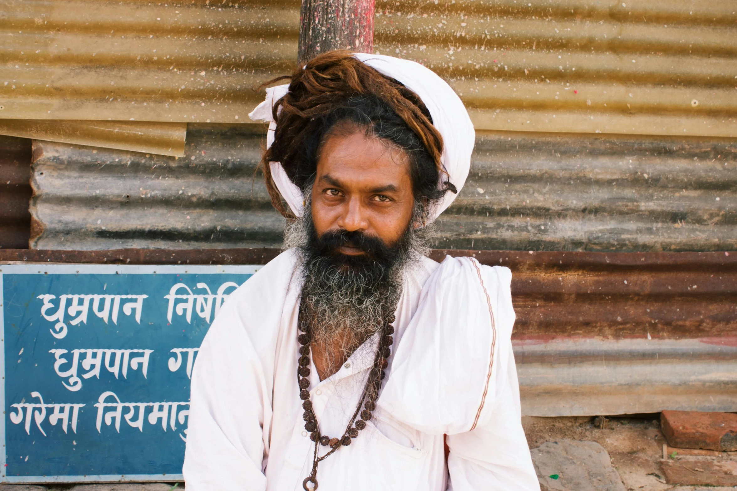 a man with a long beard and white shirt